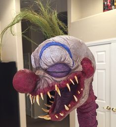 a close up of a fake monster head on a table