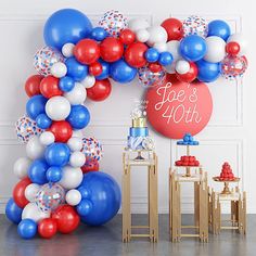 a balloon arch with red, white and blue balloons