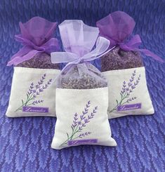 three bags filled with lavender tea sitting on top of a purple blanket