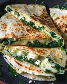 three quesadillas stacked on top of each other with cheese and spinach