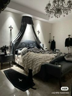 a bed room with a neatly made bed and chandelier