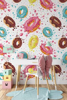 a wall with donuts painted on it next to a desk and chair in front of a rug