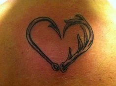 a heart shaped tattoo on the back of a woman