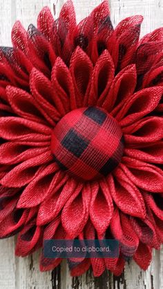 a red and black plaid flower on a white wooden background with the words, coiffed to clipboard