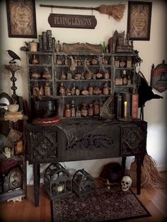 a room filled with lots of halloween decorations and decor on top of a wooden table