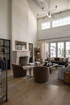 a living room filled with furniture and a fire place in the middle of a room