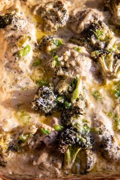 a casserole dish filled with broccoli and meat