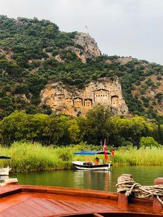 two boats in the water near a mountain