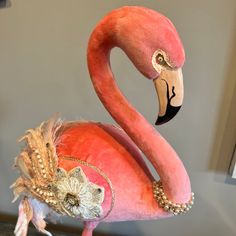 a pink flamingo wearing a fancy head piece