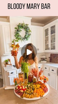 a woman standing in front of a large platter of food on top of a kitchen counter