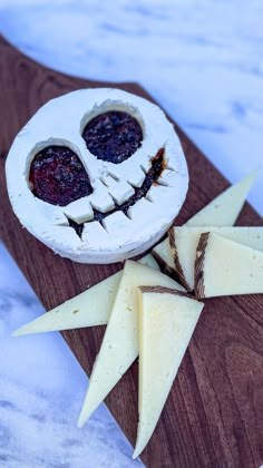 a wooden board topped with cheese and toppings