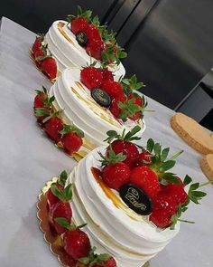 three tiered wedding cake with strawberries on top