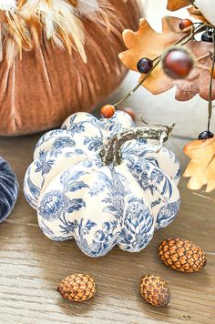 decorative blue and white pumpkins on a table