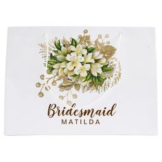 a white towel with flowers on it and the words bridesmaid matilda written in gold