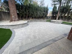 an outdoor patio with artificial grass and trees