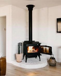 a living room with a fire place in the corner