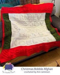 a crocheted afghan is sitting on a couch in front of a window with the words christmas bubble afghan written across it