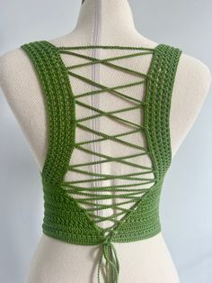 the back of a mannequin with green crochet