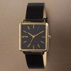 Introducing new Arvo Time Squared Watches for women! This version features a black dial and a 32mm square polished gold case that creates a classy style. The black leather band and gold buckle finish the look. This minimalist design is perfect for dress or casual wear. Add Arvo Time Squared Watches for women to your Arvo collection and get ready for compliments! PLAY the product video to see more detail! The Quick Release function of Arvo watch bands make them easy to switch out in a minute or t Classic Gold Watch For Office, Classic Gold Watches For Office, Gold Office Watch With Leather Strap, Gold Leather Strap Watch For Office, Gold Watches With Leather Strap For Office, Chic Gold Watch With Rectangular Dial, Chic Formal Watch With Rectangular Dial, Chic Formal Watches With Rectangular Dial, Classic Black Watch For Office