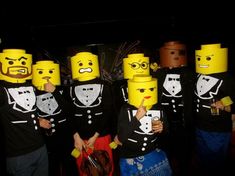 a group of people with legos on their heads standing in front of each other