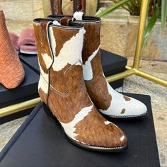 Upper: 100% Cow Leather With Hair On Outsole: 100% Cow Leather Trims: 100% Cow Leather; Lining: 100% Cow Leather 100% Cotton Professional Leather Cleaner Mid-Calf Cowboy Boot, Almond Toe, Cow Printed Haircalf, Cow Leather Piping Detail, Cross-Tack Stitch, Dual Side Pull Tabs For Easy Of Wear Scalloped Leather Welt, Leather Stacked Heel, Leather Outsole With Beveled Edges And Contrasting Black Edge Paint 55mm Leather Stacked Heel Shaft Height: 175mm Calf Hair Boots With Round Toe For Fall, Calf Hair Boots With Leather Sole And Round Toe, Bone Shoes, Leather Cleaner, Cowboy Boot, Leather Cleaning, Painting Edges, Cow Print, Stacked Heel