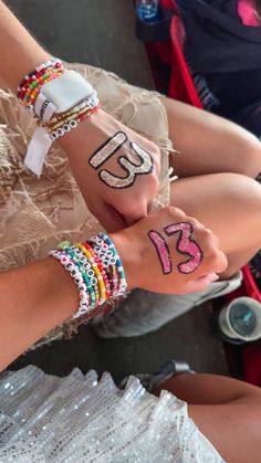 two girls with numbers painted on their hands