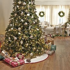 a decorated christmas tree with presents on the floor