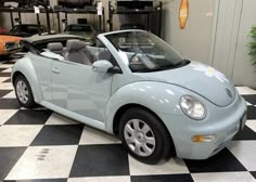 a light blue convertible car parked in a garage