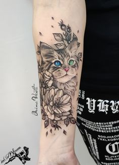 a cat with blue eyes and flowers on the arm