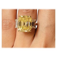 a woman's hand with a yellow and white diamond ring