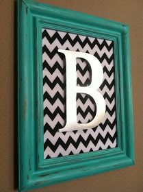 the letter b is painted in black and white chevrons with a green frame