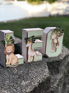 the letters are decorated with animals and plants