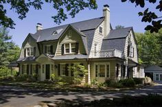 a large white house sitting in the middle of a forest