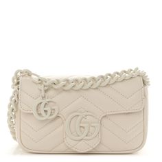 This is an authentic GUCCI Calfskin Matelasse Monochrome GG Marmont Chain Belt Bag in Mystic White.This belt bagis crafted of smooth and supple calfskin leather in ivory. This bag features a long adjustable white ceramic-effect chainbelt strap. The front crossover flapfeatures a matching interlocking white GG logo and opens to a beige microfiber interior with a silver key ring. Gucci Crossbody Bag White, Gucci Wallet White, Silver Key, Gg Logo, Gg Marmont, Chain Belt, Belt Bag, Key Ring, Key Rings