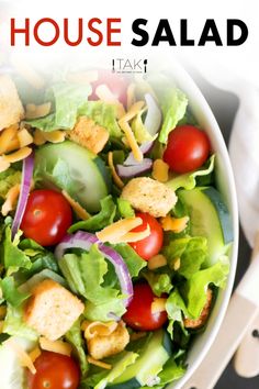 a close up of a salad in a bowl with the words house salad above it