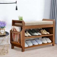 a wooden shoe rack with several pairs of shoes on it next to a table and chair