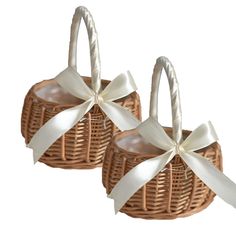 two wicker baskets with white ribbons and bows