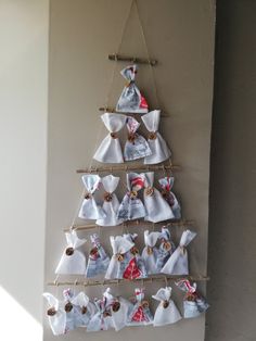 a christmas tree made out of napkins hanging on a wall