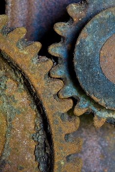 two rusty gears that are sitting next to each other