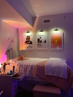 a bed room with a neatly made bed and pictures on the wall