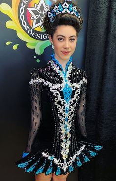 a woman in a black and blue dress posing for the camera