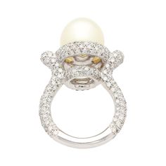 "12.3mm cultured Southsea white pearl and diamond pave set ring. Set in 18k white gold. The pearl is clean, lustrous, and very symmetrical. Adorned with 3.44 carats in natural diamonds and beautifully pointed edges above the shank.   Details:  - Metal: 18K White Gold - Size: 8  - Weight: 14.0 Grams Pearl Details: - Type: Cultured Southsea  - Size: 12.3 MM - Color: White - Luster: Excellent - Uniformity: Very good - Side Stones: 289 round cut diamonds, 3.44 carats, 1-1.5mm  SHIPPING TIMES: USA: 3 Luxury Stackable Round Pearl Ring, Luxury Diamond Pearl Ring With Pave Setting, Diamond Pearl Ring With Pave Setting For Formal Events, Diamond Pearl Ring With Pave Setting For Formal Occasions, Formal Diamond Pearl Ring With Pave Setting, Luxury Diamond White Brilliant Cut Pearl Ring, White Diamond Rings For Evening, Timeless White Gold Pearl Ring With Diamond Accents, Timeless White Gold Pearl Ring With Center Stone