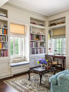 a living room filled with furniture and lots of books