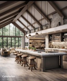 a large open kitchen with lots of counter space and stools in front of the island