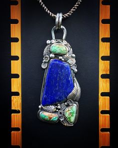 What a beautiful piece. Anyone would love to have this beautiful pendant in their collection of fine jewelry. No chain is included. Made by me, and stamped on the back with my personal hallmark. This is made with .925 silver, and has a large piece of lapis. And three pieces of turquoise. Lots of silver leaves and decorative pieces. This is a nice piece. Turquoise Pendant Necklace In Sterling Silver, Blue Engraved Turquoise Pendant Necklace, Blue Turquoise Pendant Necklace With Engraving, Collectible Sterling Silver Turquoise Gemstone Necklace, Collectible Sterling Silver Turquoise Necklace, Collectible Turquoise Gemstone Necklace In Sterling Silver, Unique Sterling Silver Turquoise Necklace Stamped 925, Unique Stamped 925 Turquoise Pendant Necklace, Art Nouveau Pendant