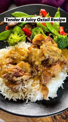 a black plate topped with rice and meat covered in gravy