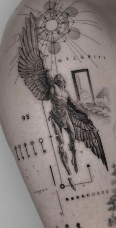 the back of a man's shoulder with an angel and key tattoo on it