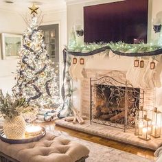 a living room with a christmas tree in the corner and a fireplace decorated for holiday