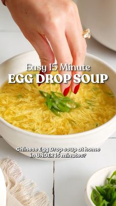 an advertisement for egg drop soup is shown in white bowl with green peppers and someone's hand