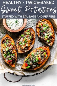 baked sweet potatoes with sausage and peppers on a plate